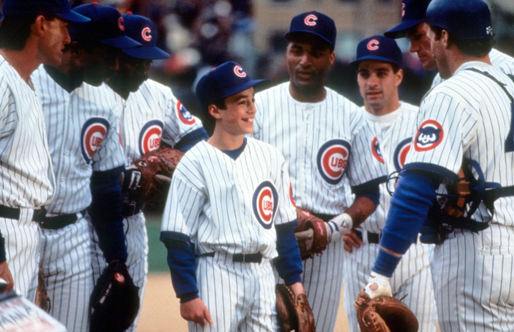 Thomas Ian Nicholas surrounded by teammates in a scene from the film 'Rookie Of The Year', 1993.