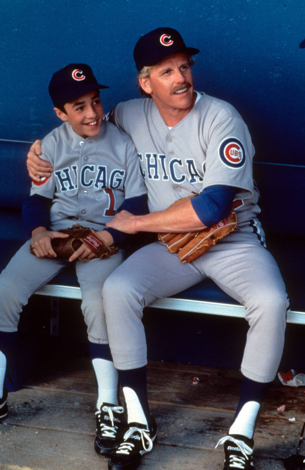 Thomas Ian Nicholas on dugout bench with Gary Busey in a scene from the film 'Rookie Of The Year', 1993.