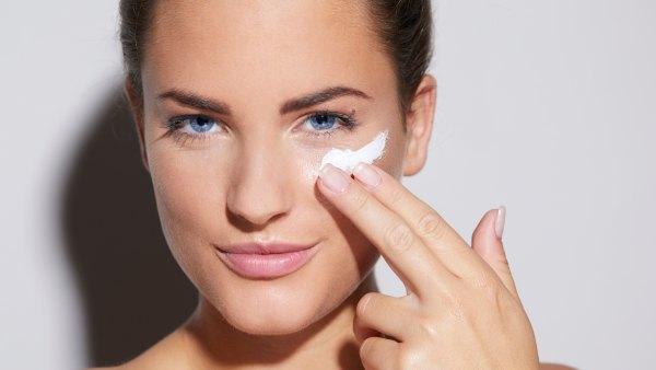 woman putting on face mask