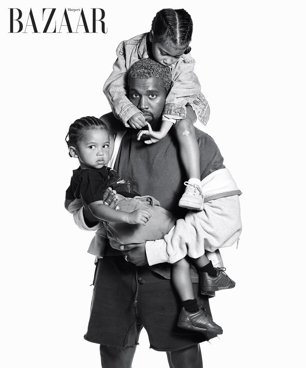 Kanye West holding North and Saint