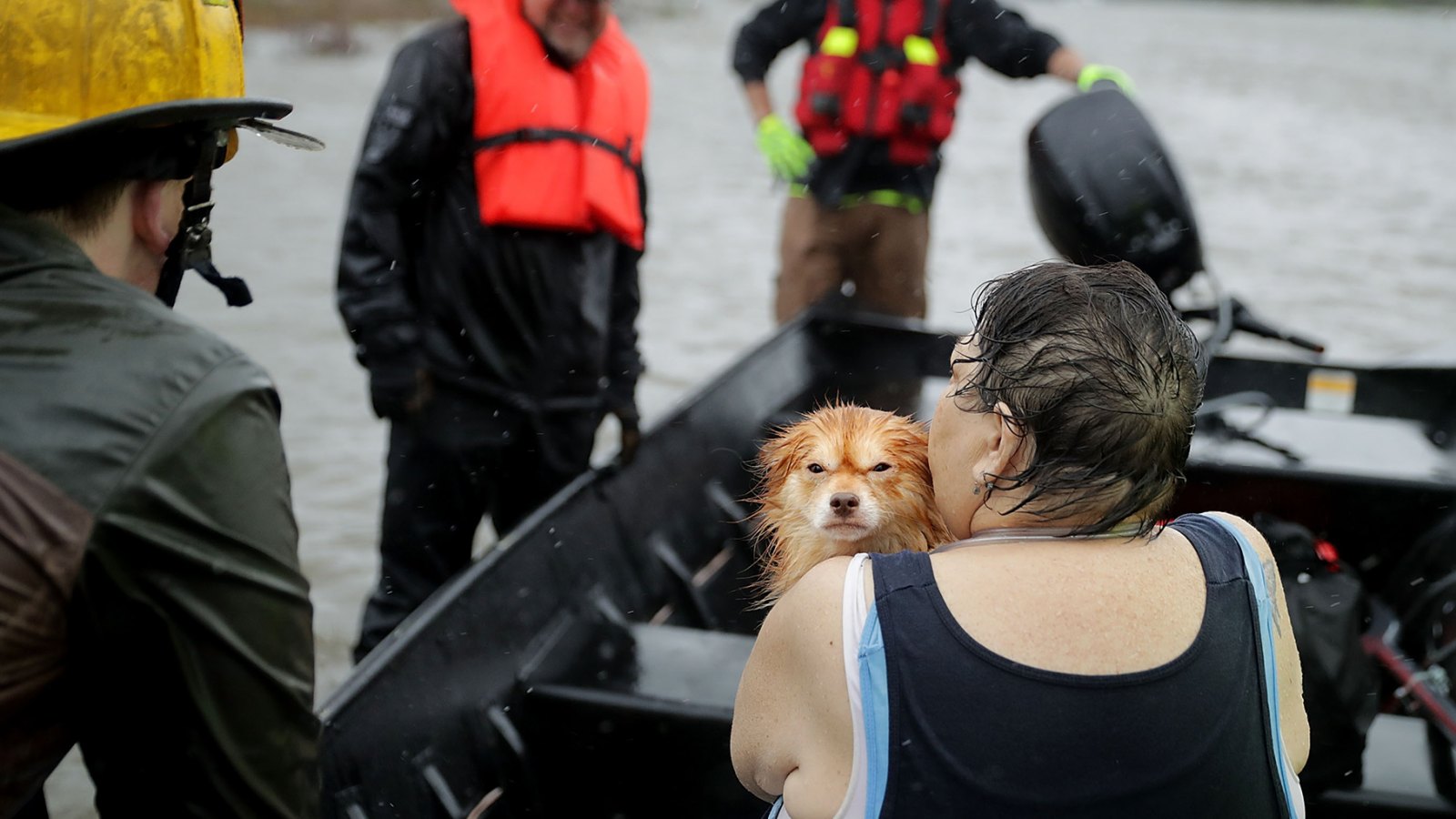 Rescue workers from Township No. 7 Fire Department and volunteers from the Civilian Crisis Response Team use a boat to rescue a woman and her dog from their flooded home during Hurricane Florence
