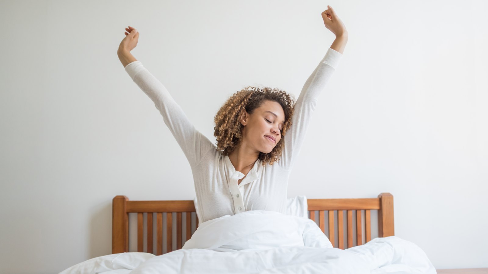 Woman yawning in bed