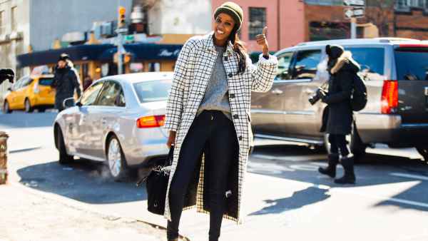 model in skinny jeans and checkered coat