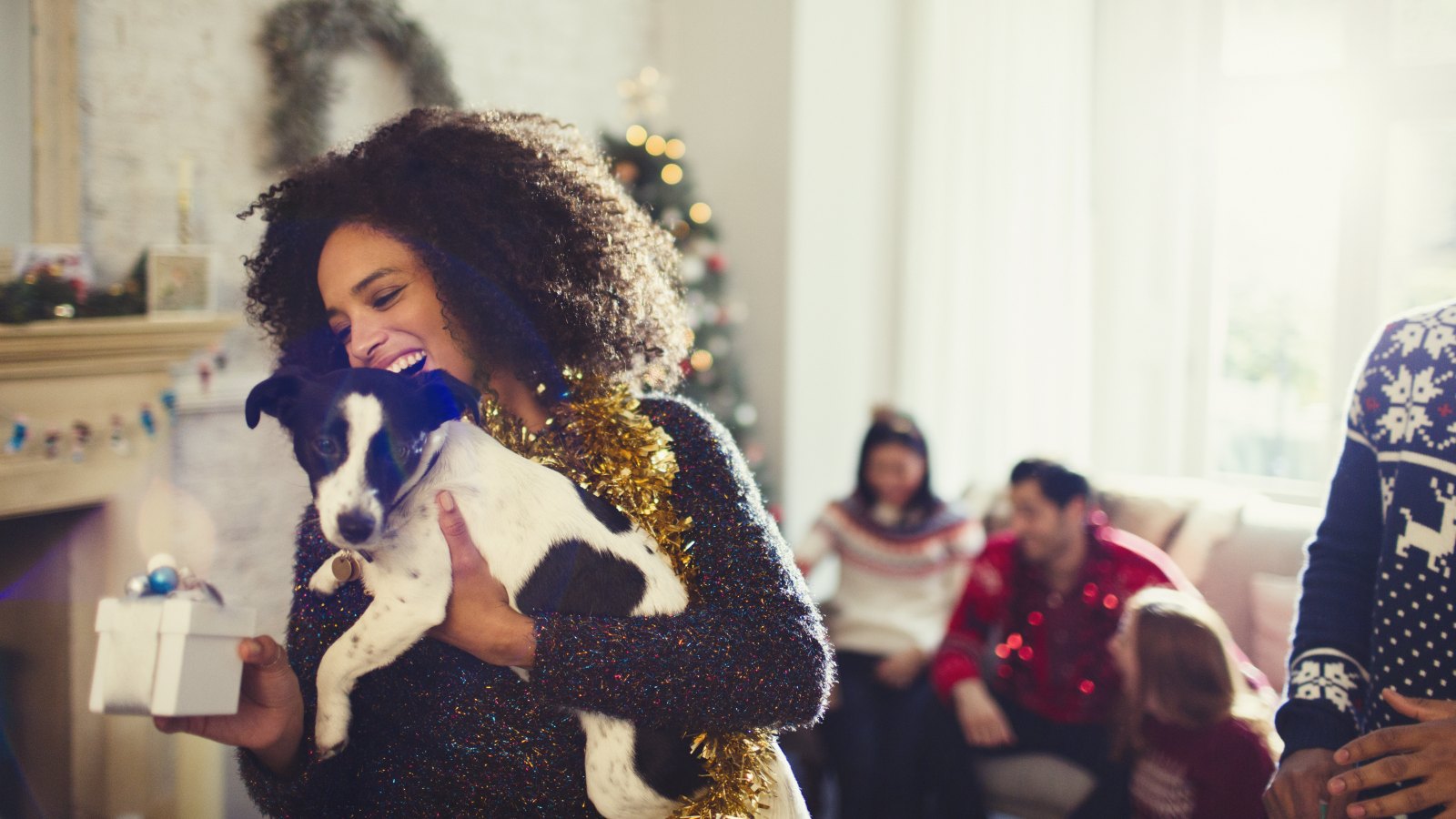 Woman holding dog and Christmas gift