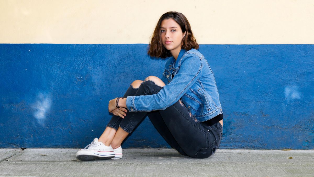 girl in a pair of jeans and a denim jacket