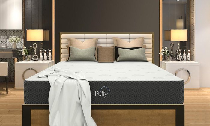 Puffy Mattress in a bedroom with throw pillows on the bed, night stands and lamps