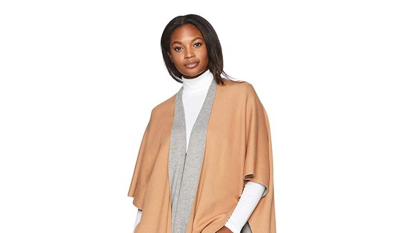 photo of a woman wearing a grey and brown poncho over a white turtleneck