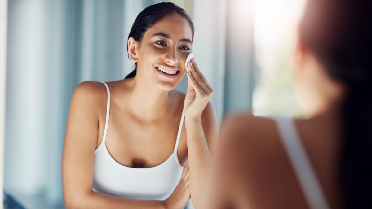 woman cleansing face