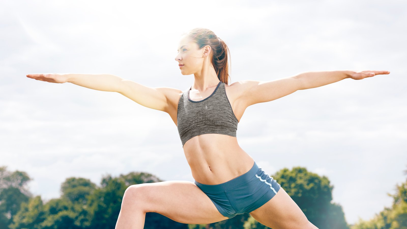 healthy female athlete in deep yoga pose