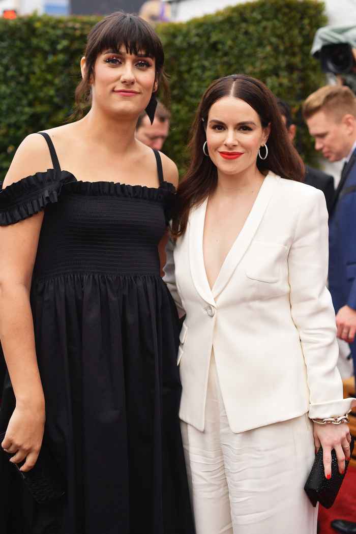teddy geiger and fiancée Emily Hampshire walk the red carpet at the 2019 Grammys