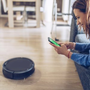 Woman Using Robot Vacuum