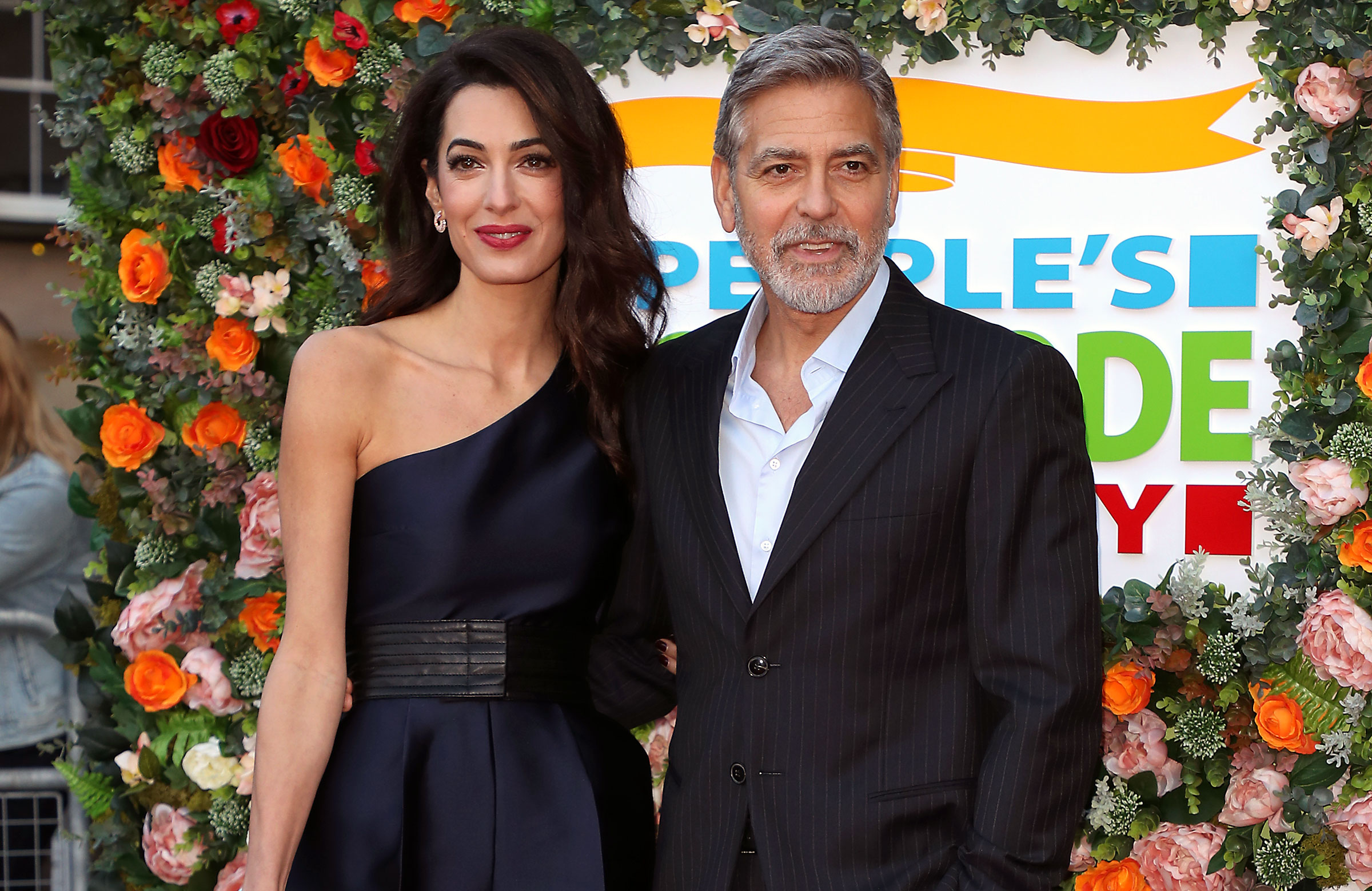 George Clooney Amal Clooney Off of Motorcycles People's Postcode Lottery Charity Gala