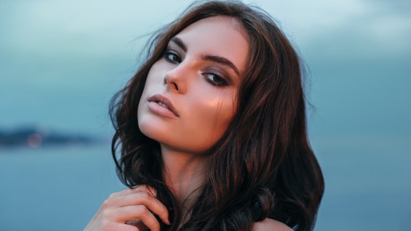 Portrait of a fresh and lovely woman posing at the beach