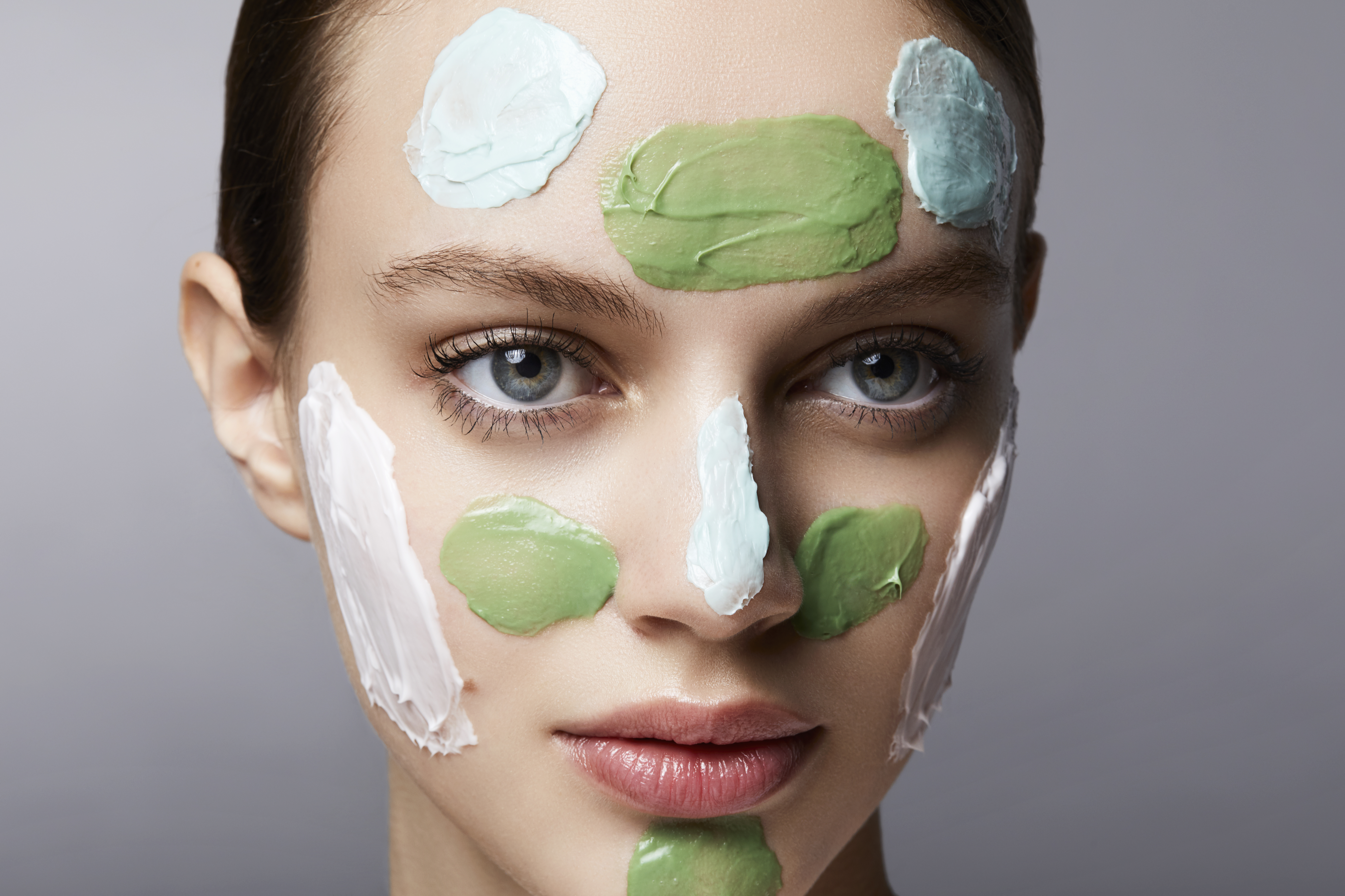young woman with different spots of facial masks