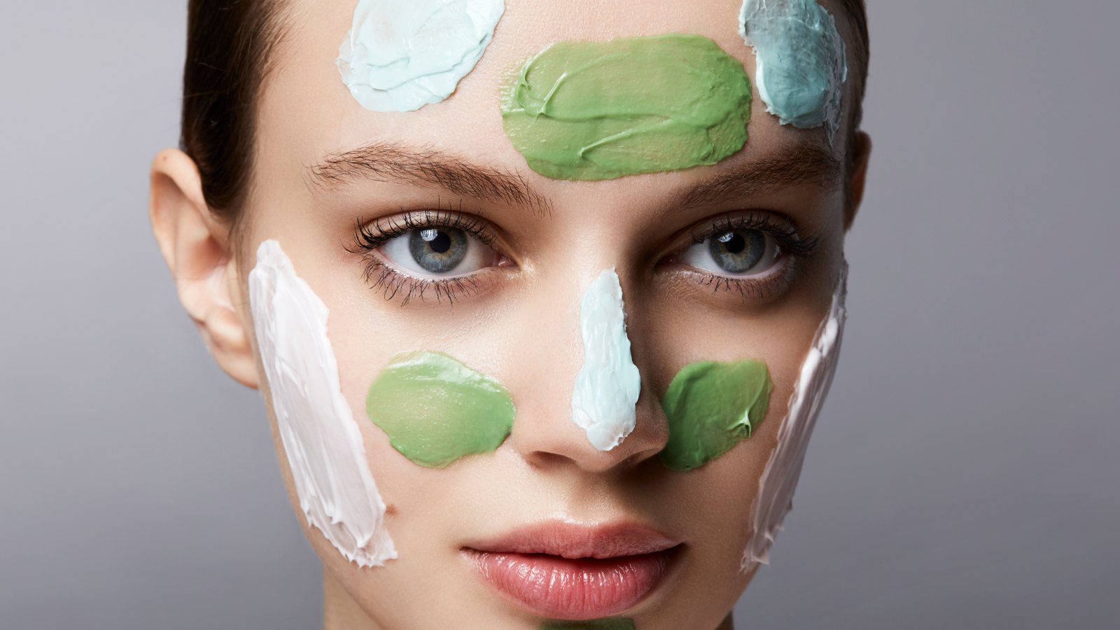 young woman with different spots of facial masks