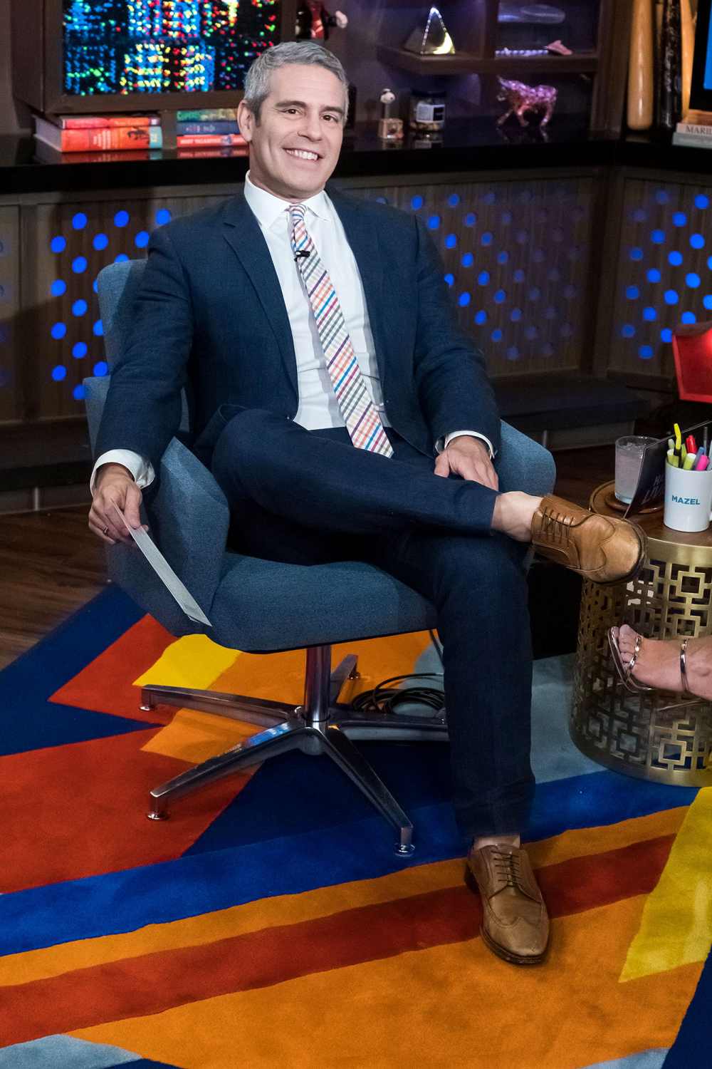 Andy Cohen Sitting in a Chair For His Show Watch What Happens Live With Andy Cohen