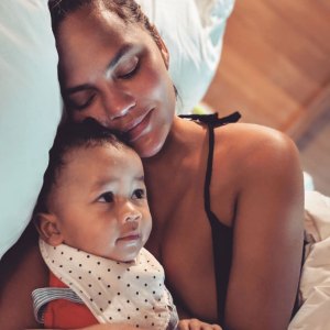 Chrissy Teigen and Miles Laying in Bed