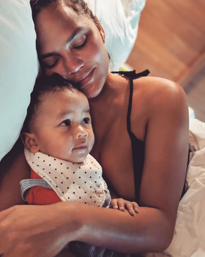 Chrissy Teigen and Miles Laying in Bed