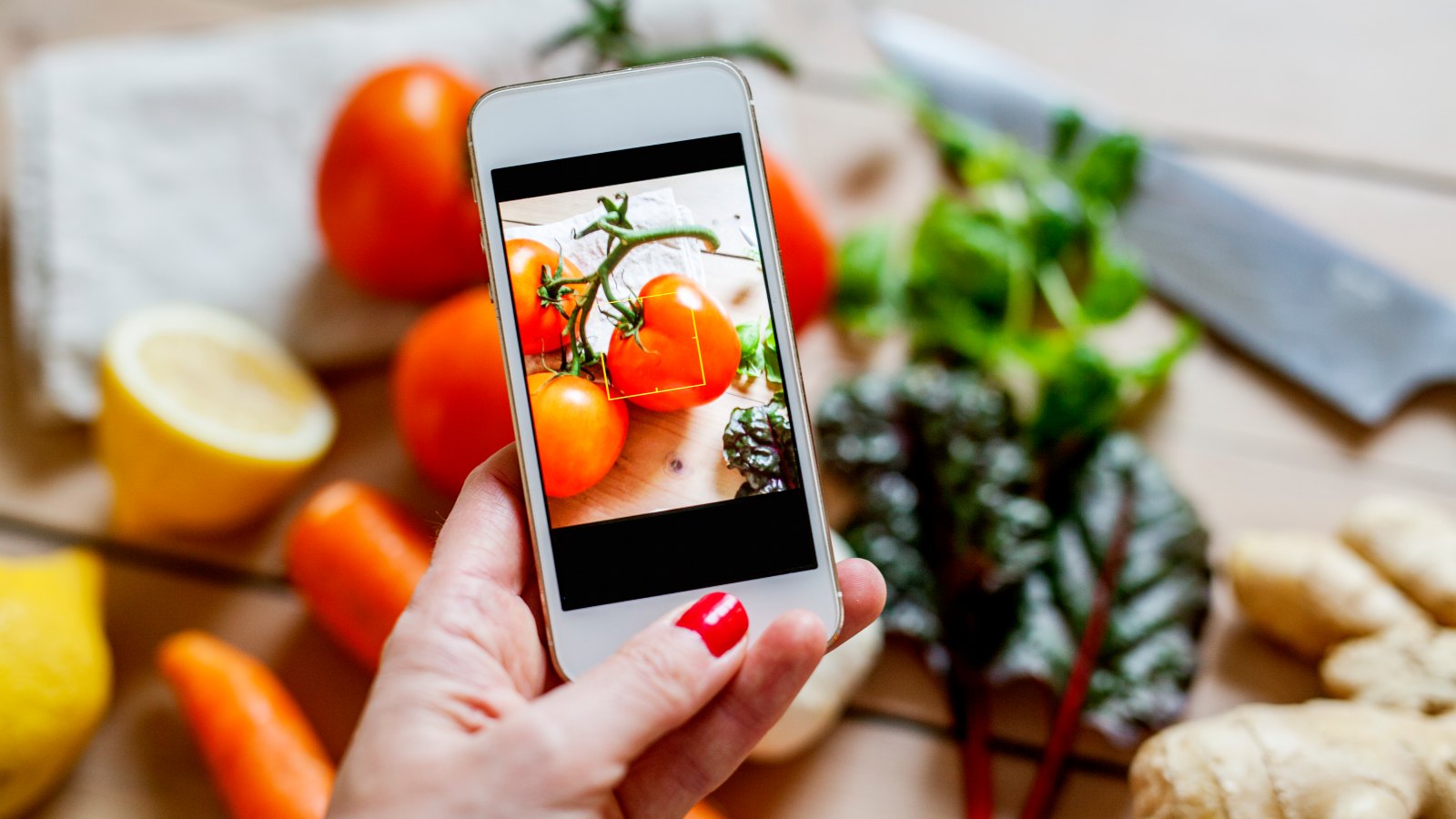 Woman photographing vegetables