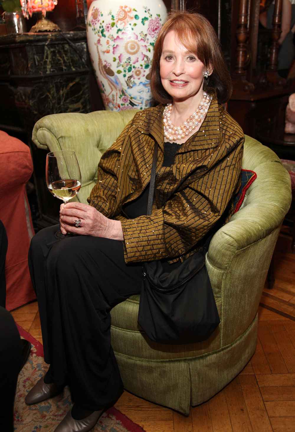 Gloria Vanderbilt Sitting Drinking a Glass of Wine