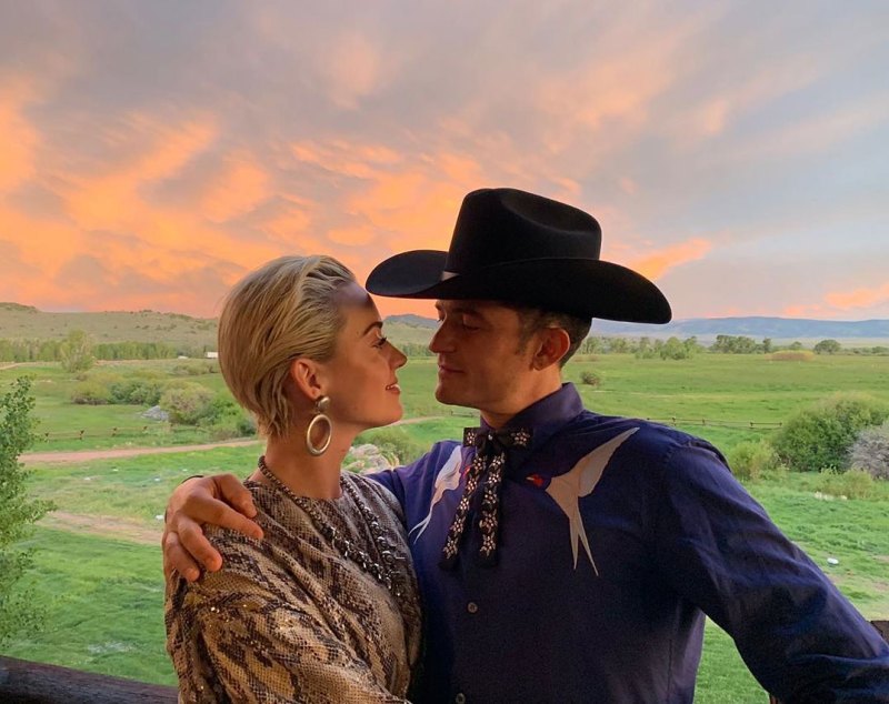 Orlando Bloom Dressed As A Cowboy Wearing a Cowboy Hat Birds on Shirt and Katy Perry At Sunset