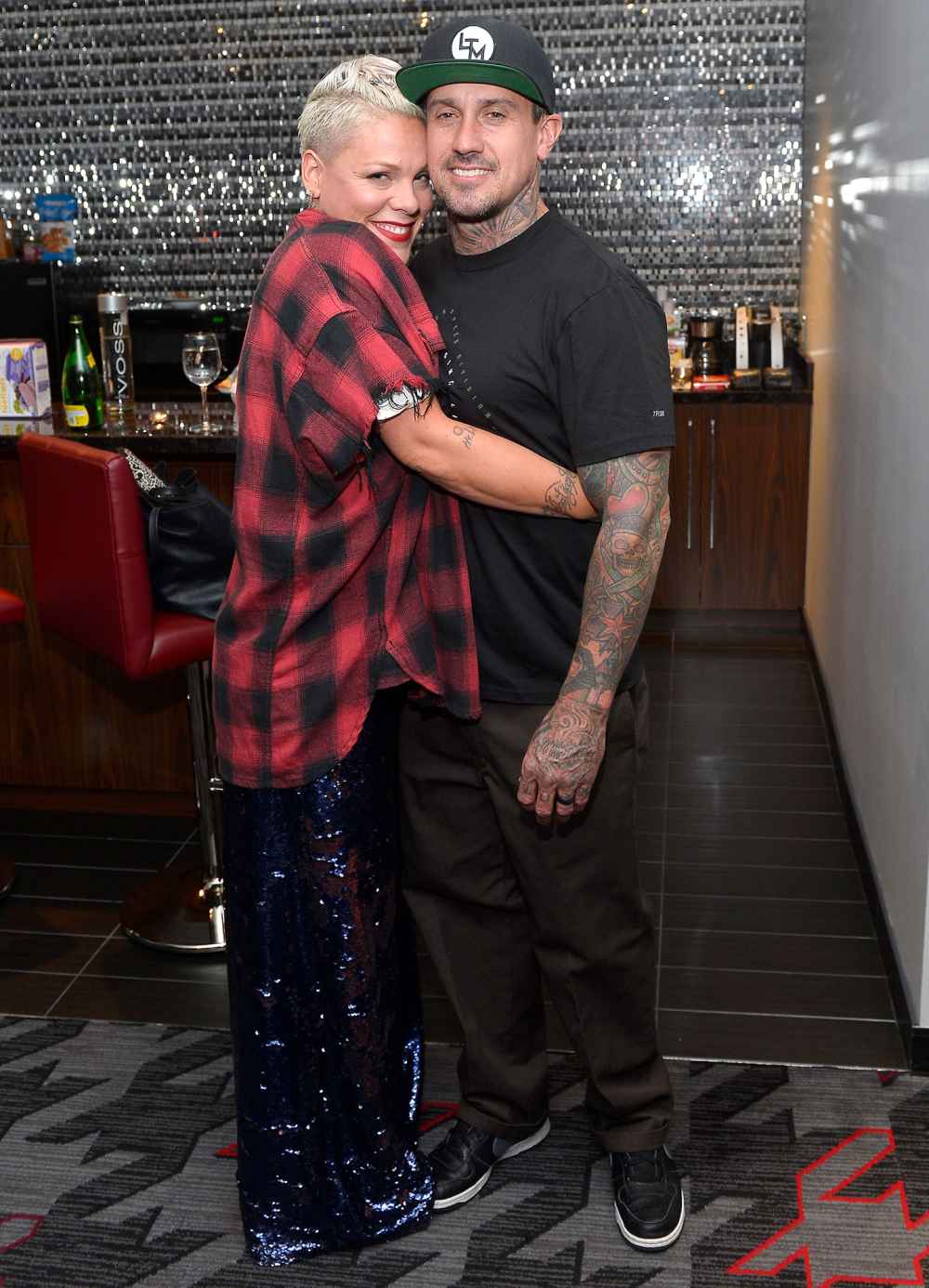 Pink Wearing Plaid and Carey Hart Hugging and Smile