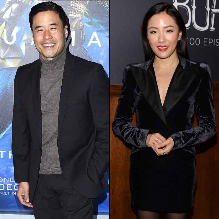Randall Park and Constance Wu Smile Wearing Black Sports Jacket and Black Dress