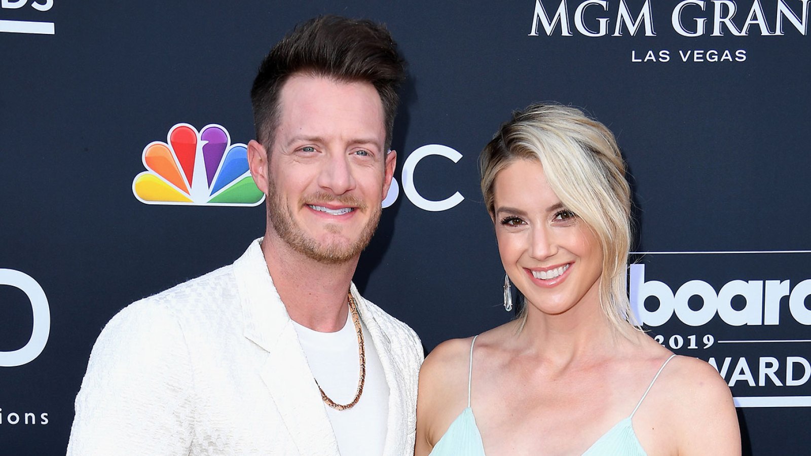 Tyler Hubbard Wearing A White Suit and Hayley Stommel Hubbard Pregnant Wearing A Blue Dress