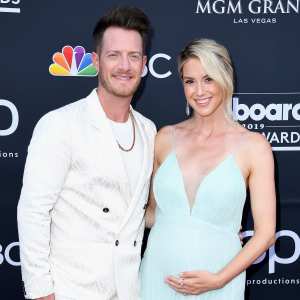 Tyler Hubbard Wearing A White Suit and Hayley Stommel Hubbard Pregnant Wearing A Blue Dress