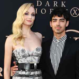 Sophie Turner Black and White Stripe Dress and Joe Jonas Black Jacket Black Pants Black and White Stripe Shirt Ring X Men Dark Phoenix