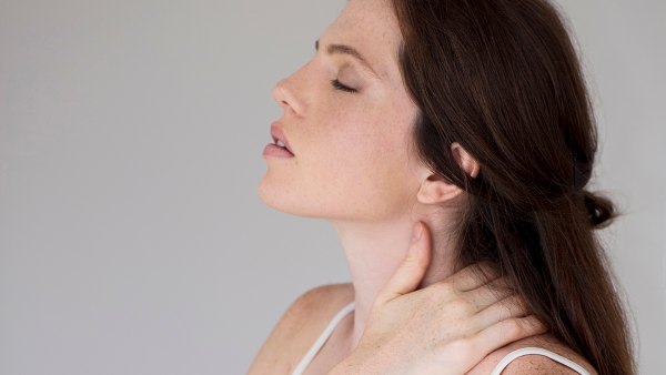 woman rubbing neck