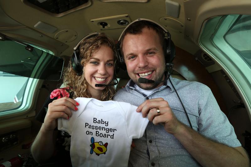John David Duggar Wife Abbie Burnett Pregnant Baby Announcement Plane Onesie