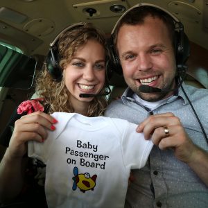 John David Duggar Wife Abbie Burnett Pregnant Baby Announcement Plane Onesie