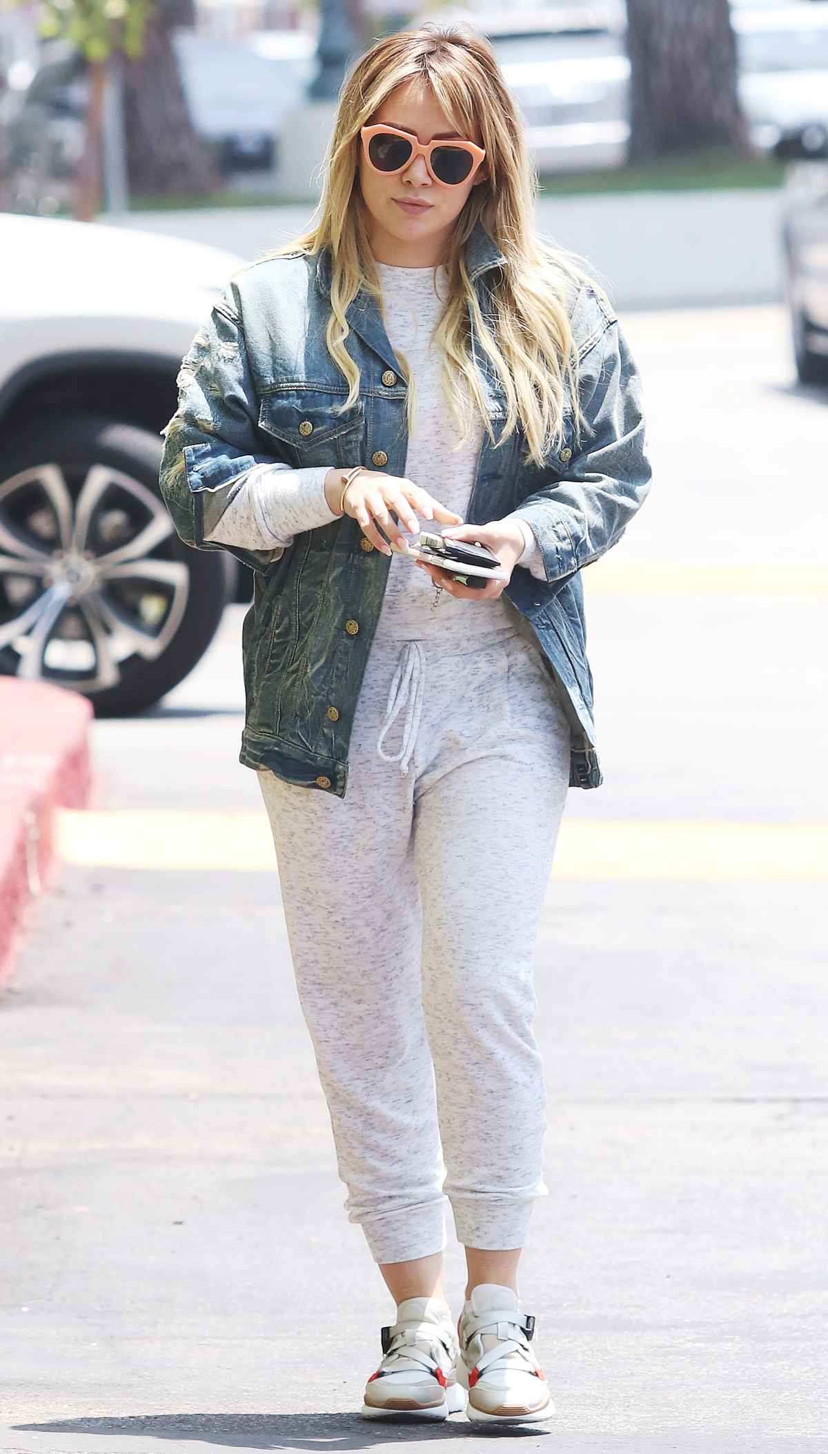 hilary duff stays a cozy in a hoodie and sweatpants while making a