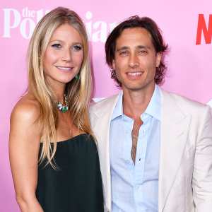 Gwyneth Paltrow Admits Brad Falchuk Waited To Move In Wearing Black Dress and White Jacket White Pants Blue Shirt Unbuttoned