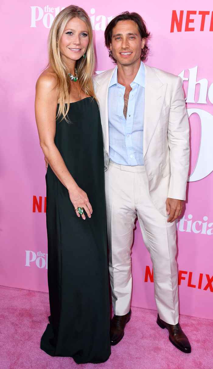 Gwyneth Paltrow Admits Brad Falchuk Waited To Move In Wearing Black Dress and White Jacket White Pants Blue Shirt Unbuttoned