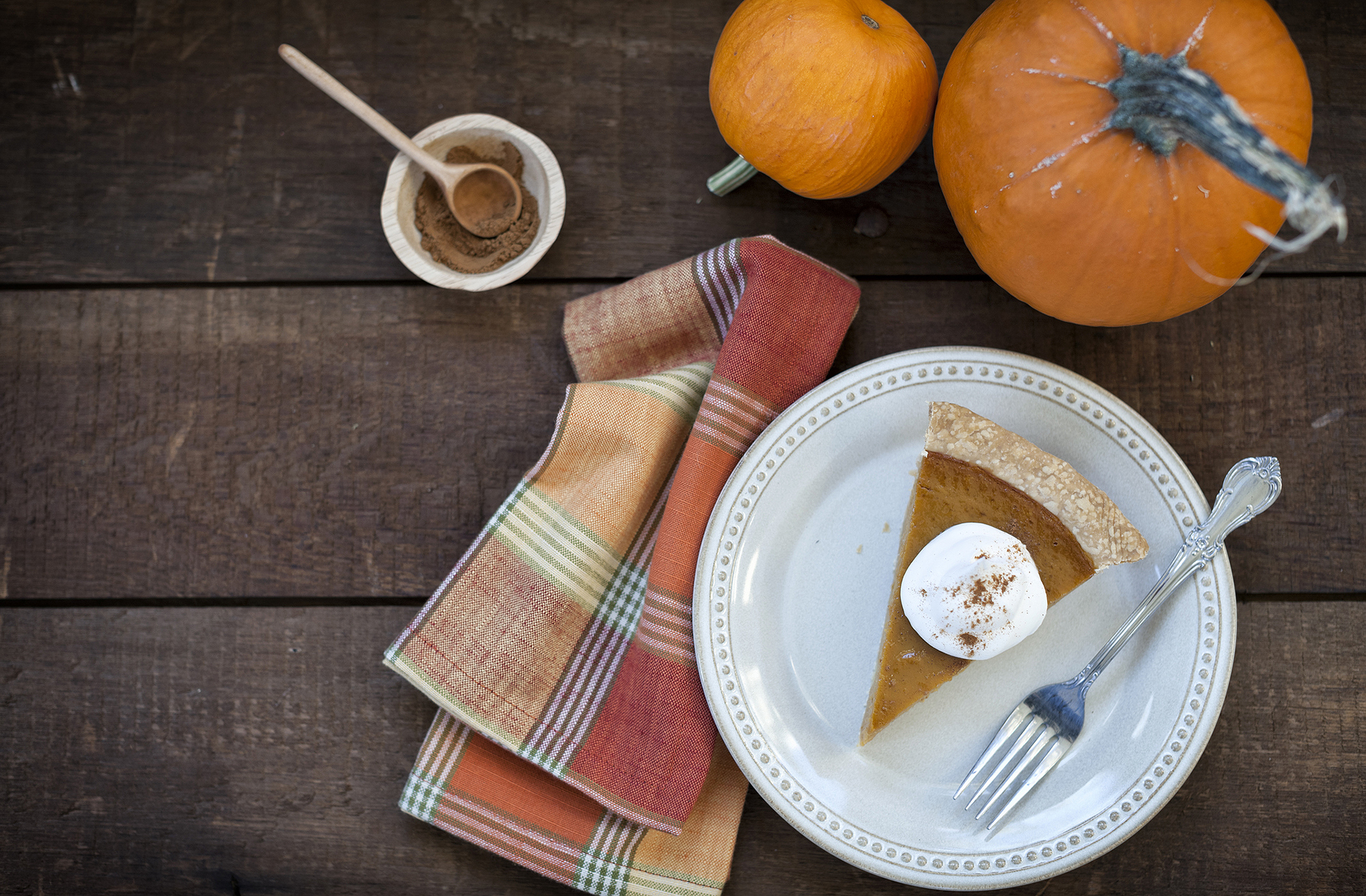 Holiday pumpkin pie with whipped topping.