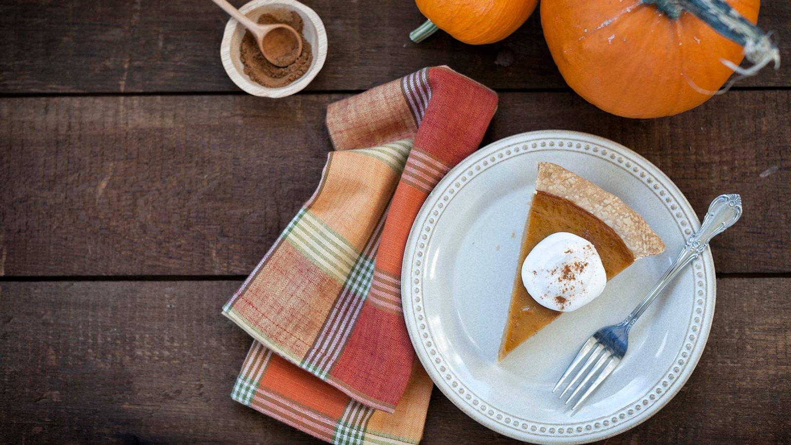 Holiday pumpkin pie with whipped topping.