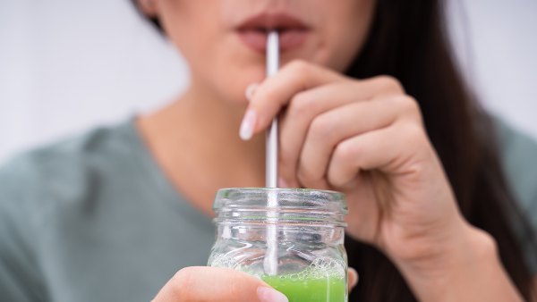 woman drinking green juice