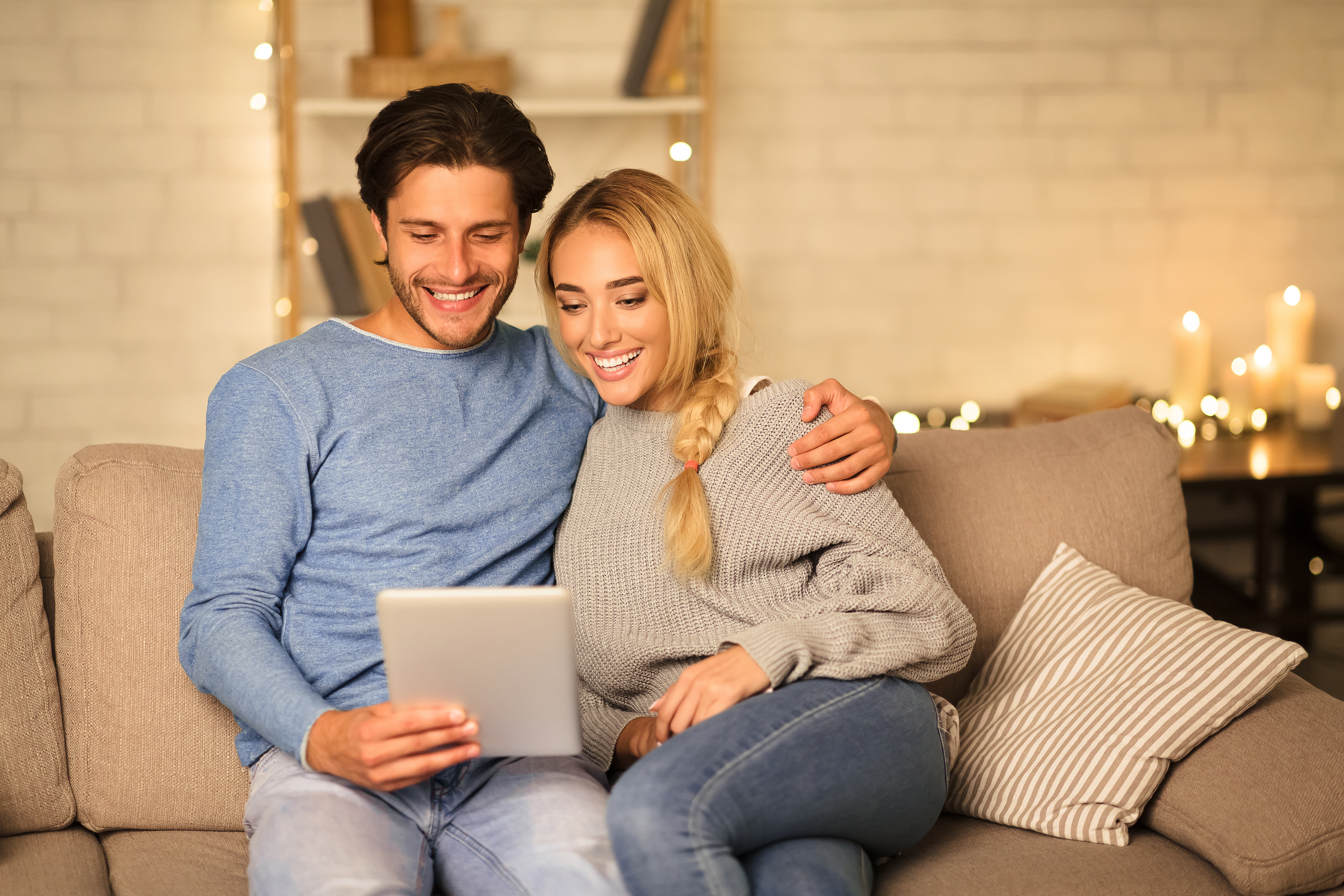 couple-looking-at-tablet