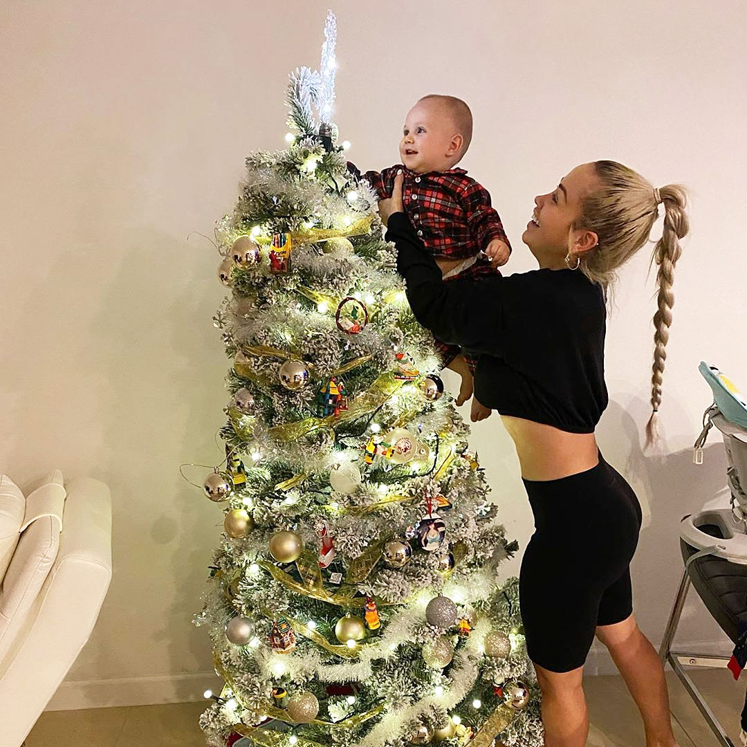Paola Mayfield Decorates Christmas Tree with Son