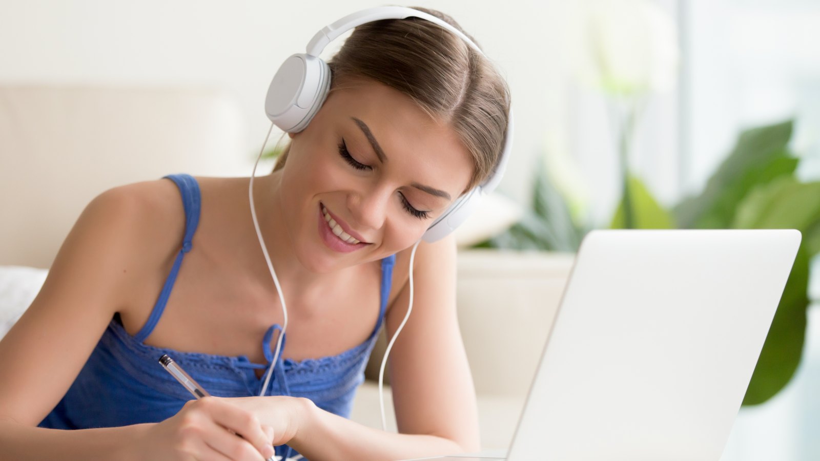 Girl listening to audio lesson on laptop