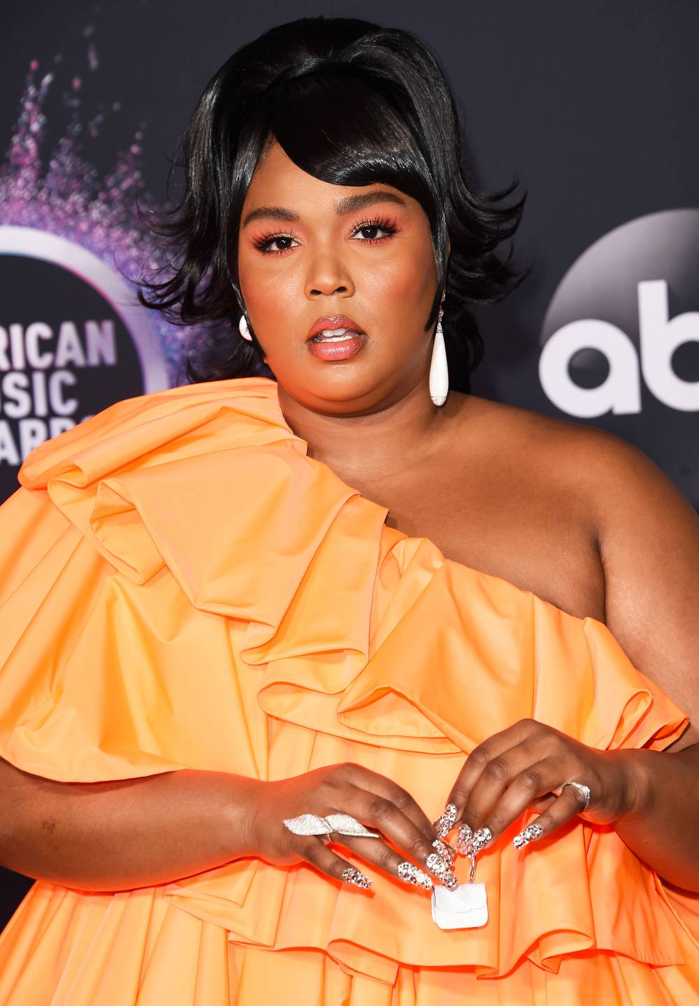 Lizzo Posts TikTok Video Pulling Random Items Out of a Tiny Purse