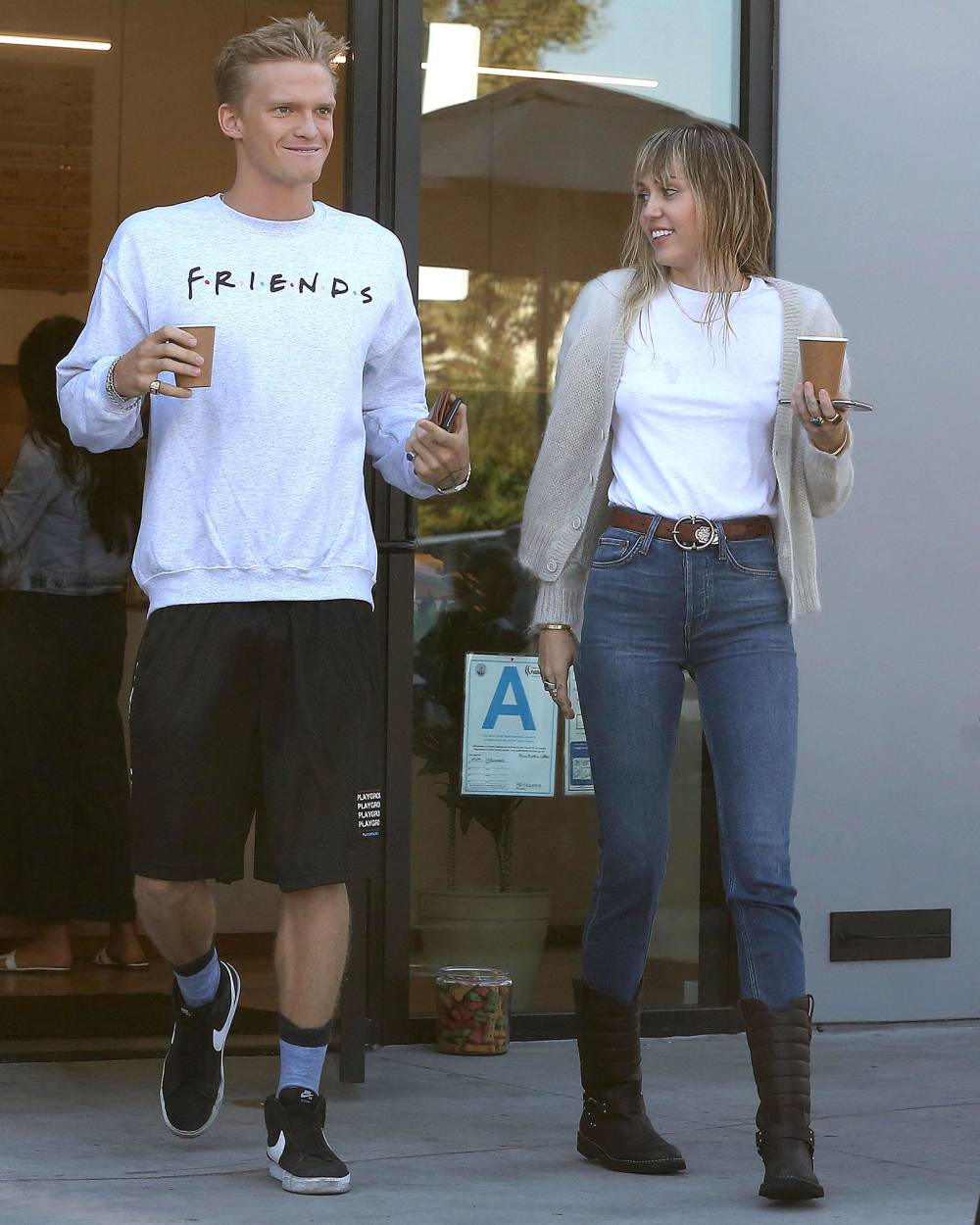 Miley Cyrus and Cody Simpson Holding Coffee Baby Plans