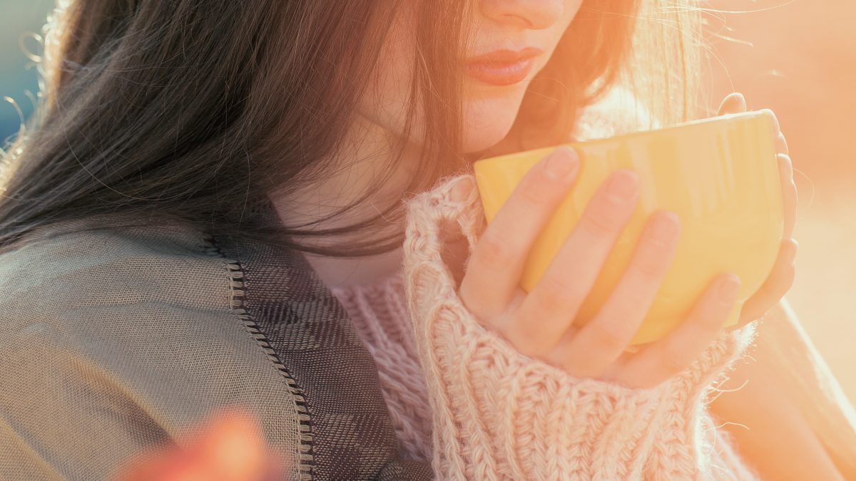 woman drinking hot cup of tea