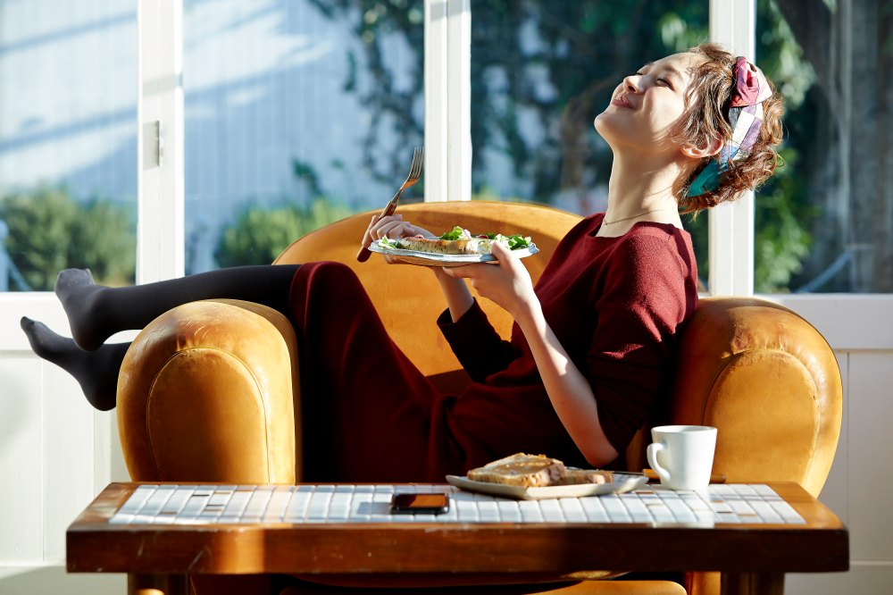 Woman enjoying a meal on her couch