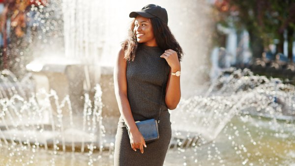 girl standing in front of a fountain