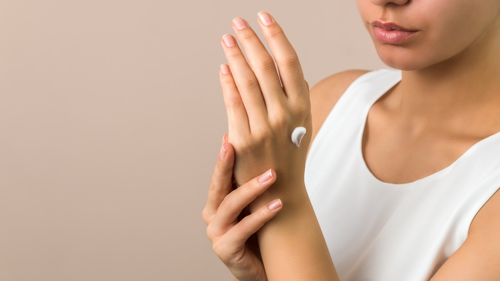woman moisturizing skin