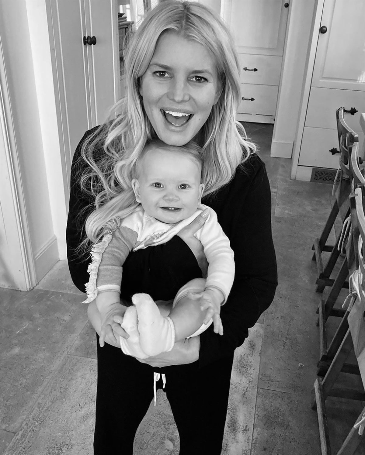 Jessica Simpson beams while holding her six-month-old daughter