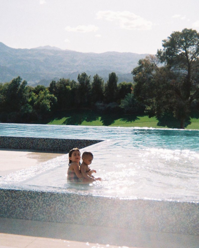 Penelope Disick playing with Psalm West in a Palm Springs pool